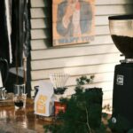 Coffee grinder and equipment in a cafe interior with warm ambient lighting