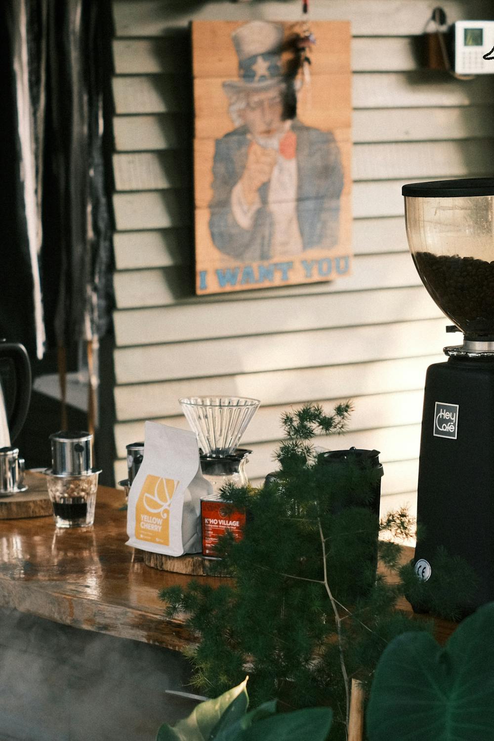 Coffee grinder and equipment in a cafe interior with warm ambient lighting