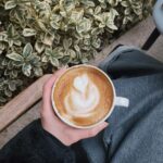 Latte in a ceramic cup at a cafe table