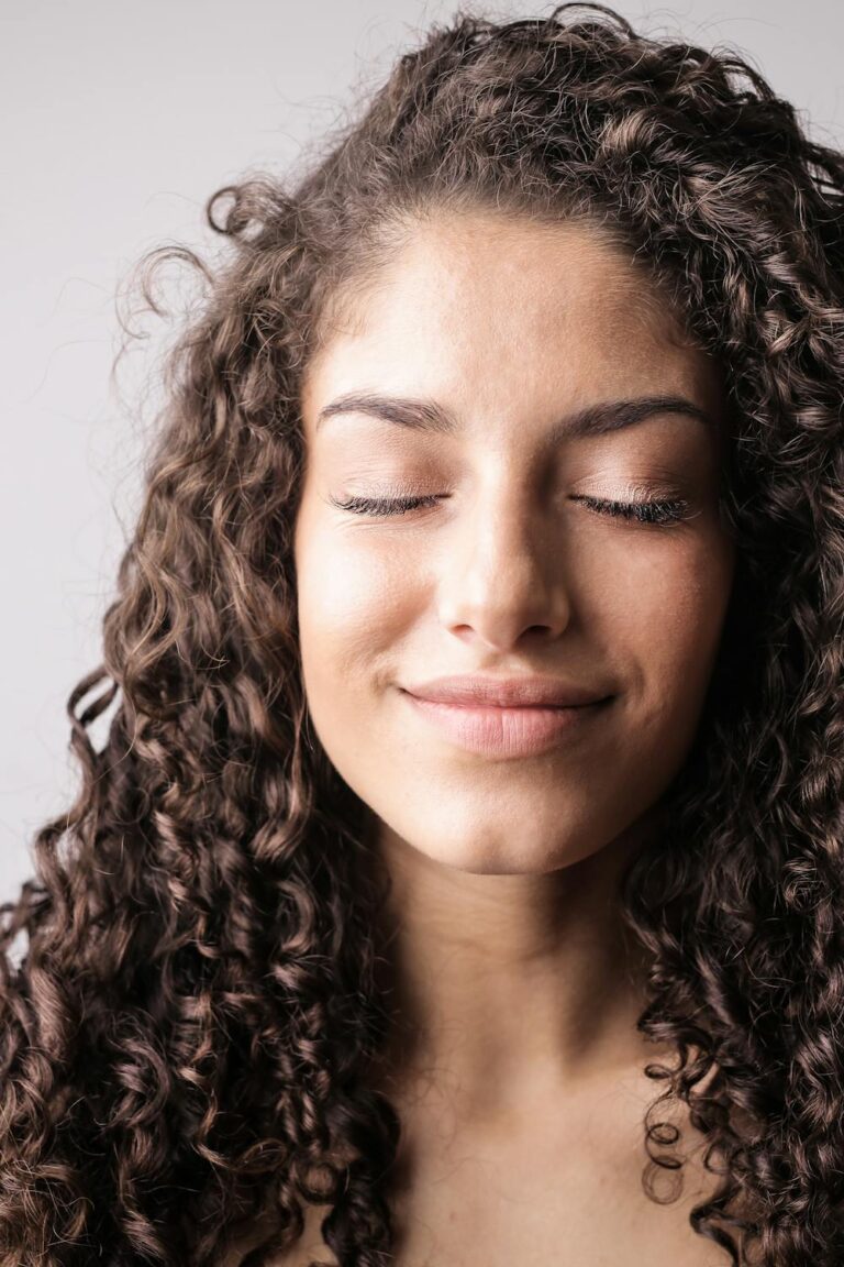 Woman with natural curly hair in a bright outdoor setting