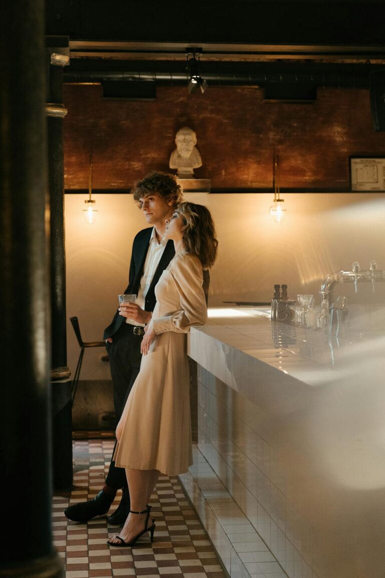 Woman in an elegant neutral outfit with strappy heels on a date night at a restaurant