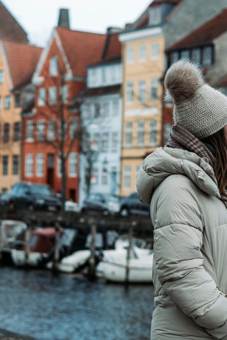 Woman solo traveling in Europe posing beside a picturesque canal