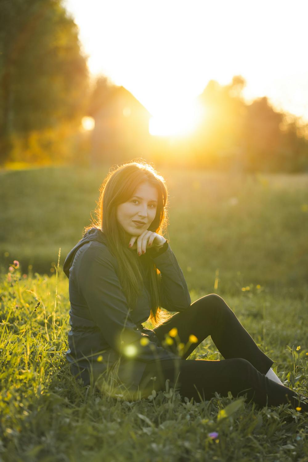 Woman standing outdoors at golden hour with warm amber light