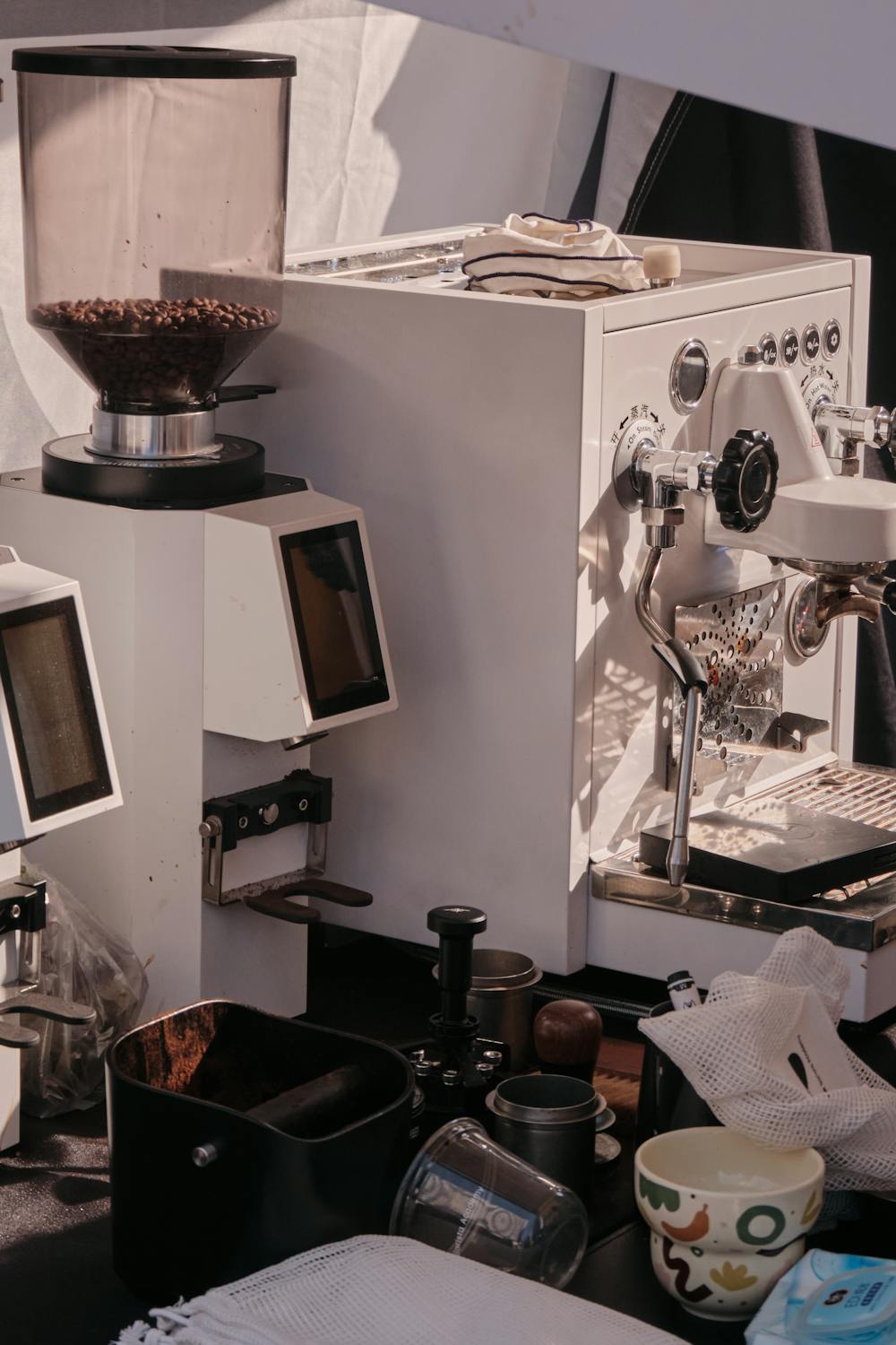 Espresso machine and coffee grinder on a clean kitchen counter