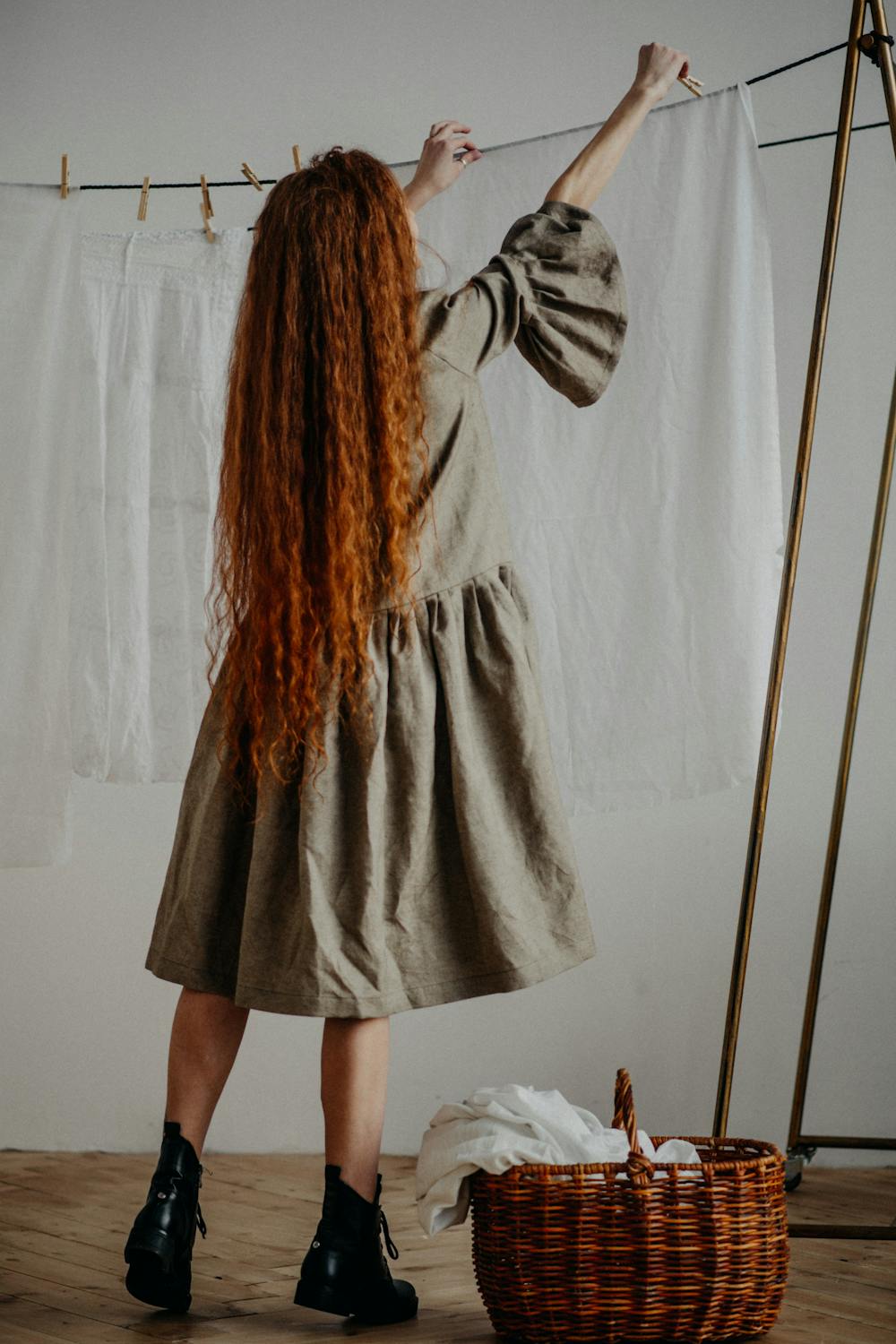 Woman wearing a natural linen dress in a clean outdoor setting
