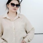 Woman in an elegant old money aesthetic outfit with tailored pieces and neutral tones