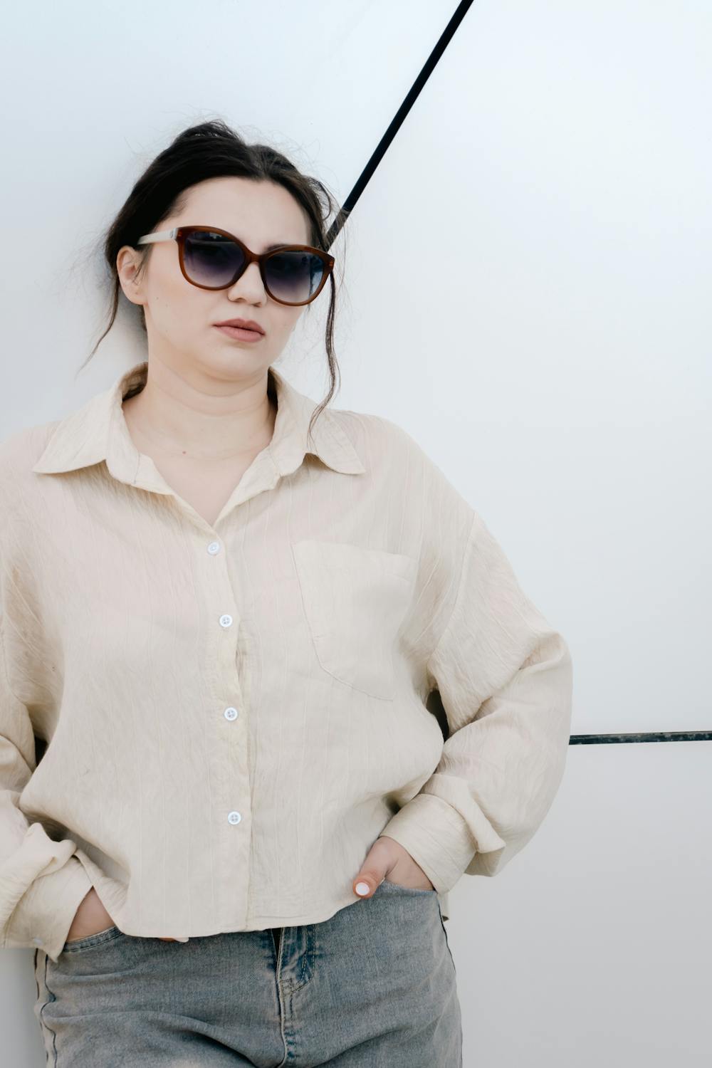 Woman in an elegant old money aesthetic outfit with tailored pieces and neutral tones