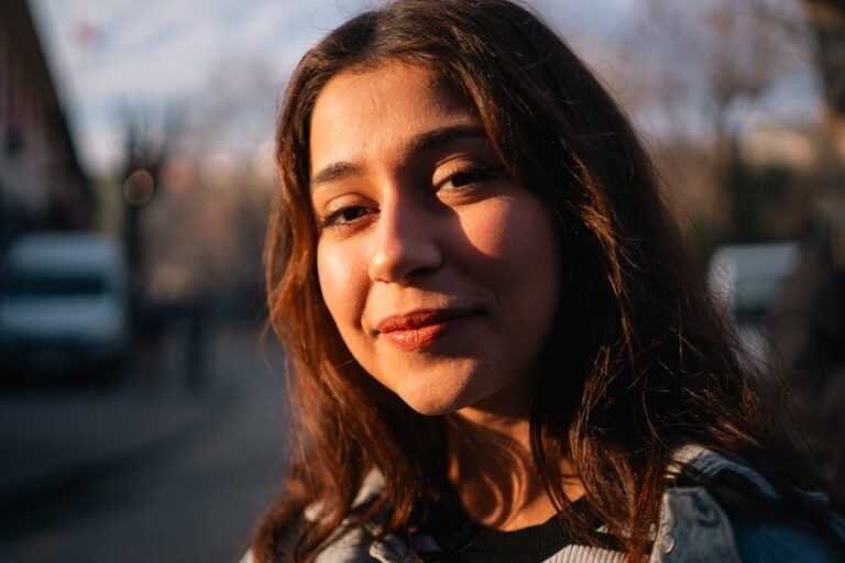 Young woman smiling in natural light outdoor portrait