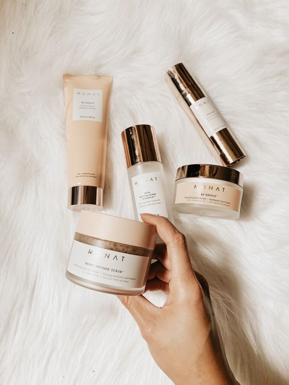 Skincare and beauty products flat lay on warm neutral surface